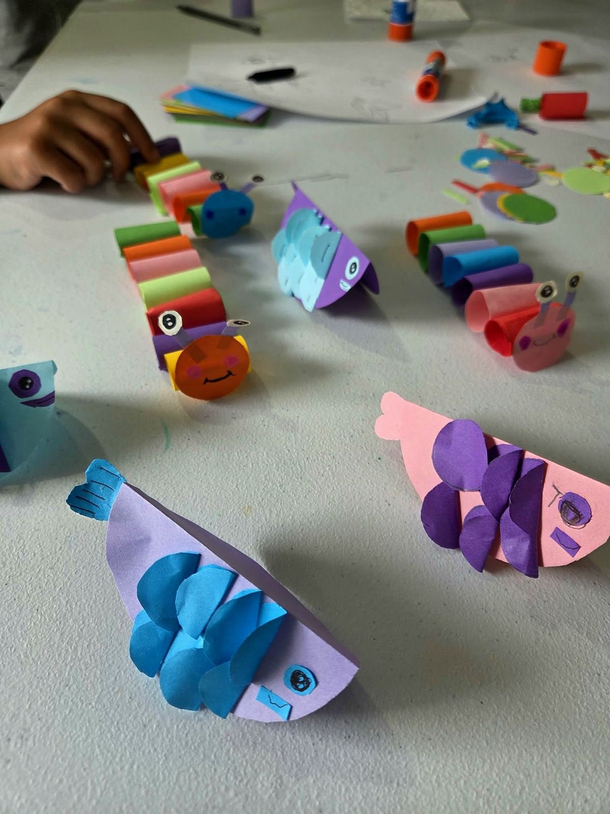 Student Paper Hand Craft — paper fish and caterpillar creations, group view